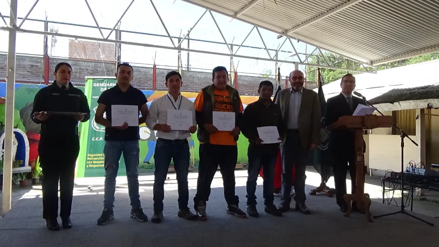 Artesanos sosteniendo sus certificados al terminar la capacitación en oficio de madera